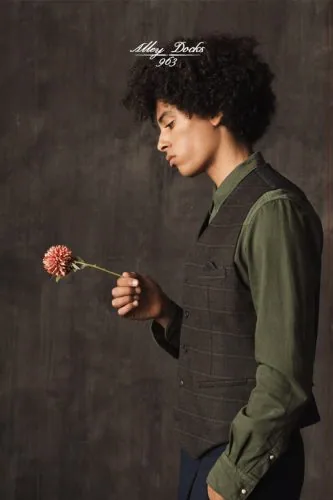 Model in a green vest holding a flower, Alley Docks campaign