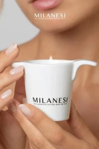 Hands holding a massage candle, Milanesi campaign, natural cosmetics