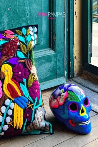 Colorful embroidered cushion and a decorated skull, Pink Pampas campaign